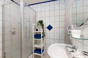 a bathroom with a white sink and a shower at Grüner Ausblick in Oberkirch +18 photos
