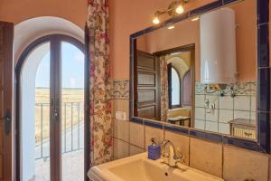 a bathroom with a sink and a mirror at Apartamentos Valsequillo Córdoba in Valsequillo +65 photos