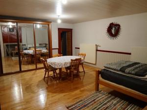 a living room with a table and chairs and a bed at Ancienne petite ferme in Châtelblanc