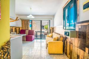 a living room with a couch and a table at Mirage Arillas Studio Type A2 in Arillas