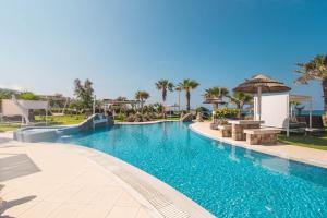 a swimming pool at a resort with a swimming pool at Mirage Arillas Studio Type A2 in Arillas
