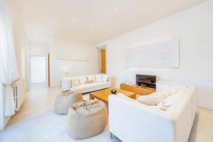 a living room with two white couches and a table at Casa Con Piscina En Selva in El Port de la Selva