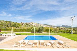 a swimming pool with lounge chairs and a swimming pool at Casa Con Piscina En Selva in El Port de la Selva