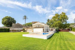 a house with a large yard with a swimming pool at Casa Con Piscina En Selva in El Port de la Selva