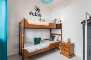 a bedroom with two bunk beds and a nightstand at Geo House in Vila do Bispo