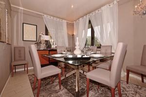 a dining room with a table and chairs at Villa Grazia in Manerba del Garda
