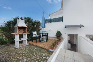 a patio with a table and a bird house at Economy Studio for Two in Lagos in Lagos +8 photos