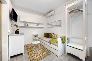 a small living room with a couch and a tv at Economy Studio for Two in Lagos in Lagos