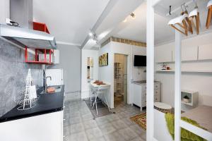 a kitchen and a living room with white walls at Economy Studio for Two in Lagos in Lagos