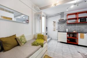 a living room with a couch and a kitchen at Economy Studio for Two in Lagos in Lagos