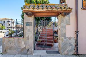 an entrance to a building with a gate at Camere La Ro Ca- Telti in Telti