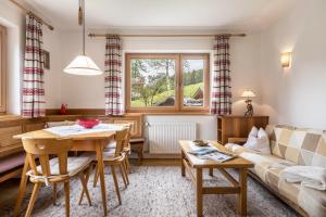 a living room with a table and a couch at Cësa Gravina Jubas in Ortisei