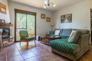 a living room with a couch and a fireplace at La Huerta Del Sur in Alhaurín el Grande