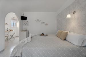 a bedroom with a large bed in a white room at Loft Pension Candelaria in Valle Gran Rey