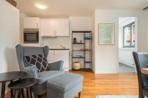 a living room with a couch and a chair and a table at 1 Zimmer-appartment Nr 12 in Wangen im Allgäu +17 photos