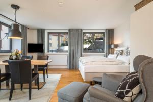 a living room with a bed and a dining room at 1 Zimmer-appartment Nr 12 in Wangen im Allgäu