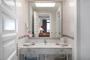a bathroom with a sink and a mirror at Los Molinos 4306 in Costa Teguise +14 photos