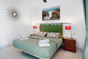 a bedroom with a bed with two towels on it at Los Molinos 4306 in Costa Teguise