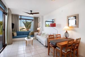 a living room with a table and a couch at Los Molinos 4306 in Costa Teguise