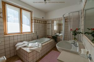 a bathroom with a tub and a sink at Villa Archi in Colico +7 photos