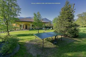 a ping pong table in the yard of a house at Villa Archi in Colico