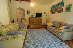 a living room with two couches and a dresser at Villa Archi in Colico