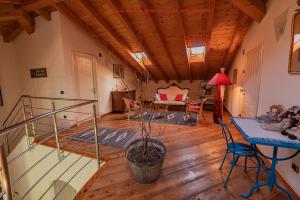 a living room with a staircase and a table at Villa Archi in Colico