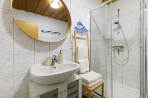 a bathroom with a sink and a mirror and a shower at Ferienhaus am Neubäuer See in Roding +31 photos
