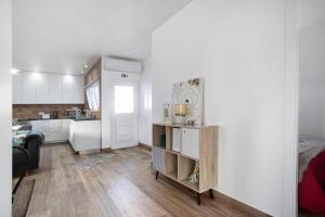 a small kitchen with white walls and wooden floors at Casa da Padaria in Leiria