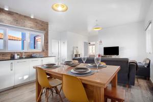 a dining room and living room with a table and chairs at Casa da Padaria in Leiria
