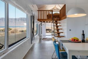 a kitchen and dining room with a table and chairs at El Loft in Famara