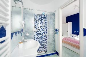 a bathroom with a shower with a sink and a toilet at Coast 2 Coast in Agerola +49 photos