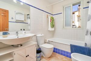a bathroom with a sink and a toilet and a tub at La Casita Azul in Almuñécar +32 photos