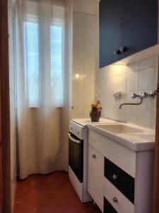 a kitchen with a sink and a stove at Meridiana case al mare in Mattinata +36 photos