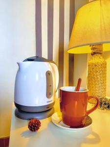 a coffee maker and a cup on a table at Meridiana case al mare in Mattinata