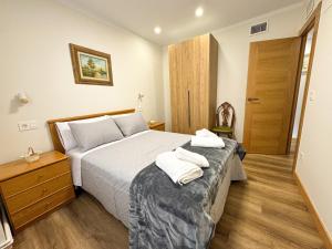 a bedroom with a bed with two towels on it at Casa rural La abuela in Mainar +36 photos