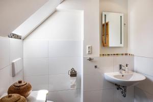 a white bathroom with a sink and a mirror at Forsthof Schulte in Pronstorf +22 photos