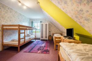 a bedroom with two bunk beds and a computer monitor at Großes Gästehaus in Sudwalde +16 photos