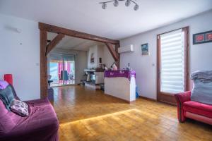 a living room with two couches and a kitchen at Villa Arbre de Vie in La Crau