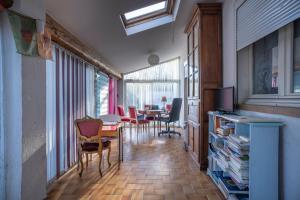 a living room with a table and chairs at Villa Arbre de Vie in La Crau