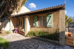 a small house with a porch and a patio at Villa Arbre de Vie in La Crau
