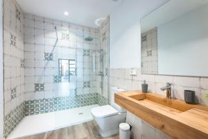 a bathroom with a toilet and a sink at Albercutx Pollentia 1 2 3 in Pollença +37 photos
