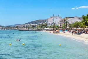 a group of people swimming in the water at a beach at Albercutx Pollentia 1 2 3 in Pollença