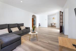 a living room with a couch and a table at Albercutx Pollentia 1 2 3 in Pollença