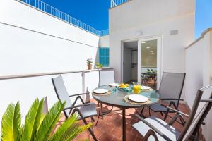 a patio with a table and chairs on a balcony at Albercutx Pollentia 1 2 3 in Pollença
