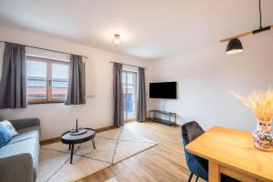 a living room with a couch and a table at Ferienwohnung Max in Gilching