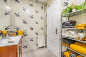 a bathroom with a sink and a white door at Casa pablo y francisca in Alfarrás +30 photos