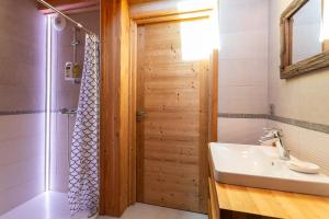 a bathroom with a sink and a shower and a mirror at Chalet Le Chastel in Pelvoux +15 photos