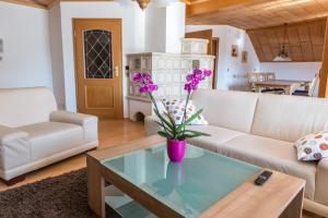 a living room with a couch and a table at Ferienwohnung Maria in Liggersdorf