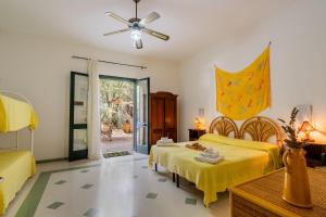 a bedroom with two beds and a ceiling fan at Domus mea salento Arazzo Giallo in Ugento